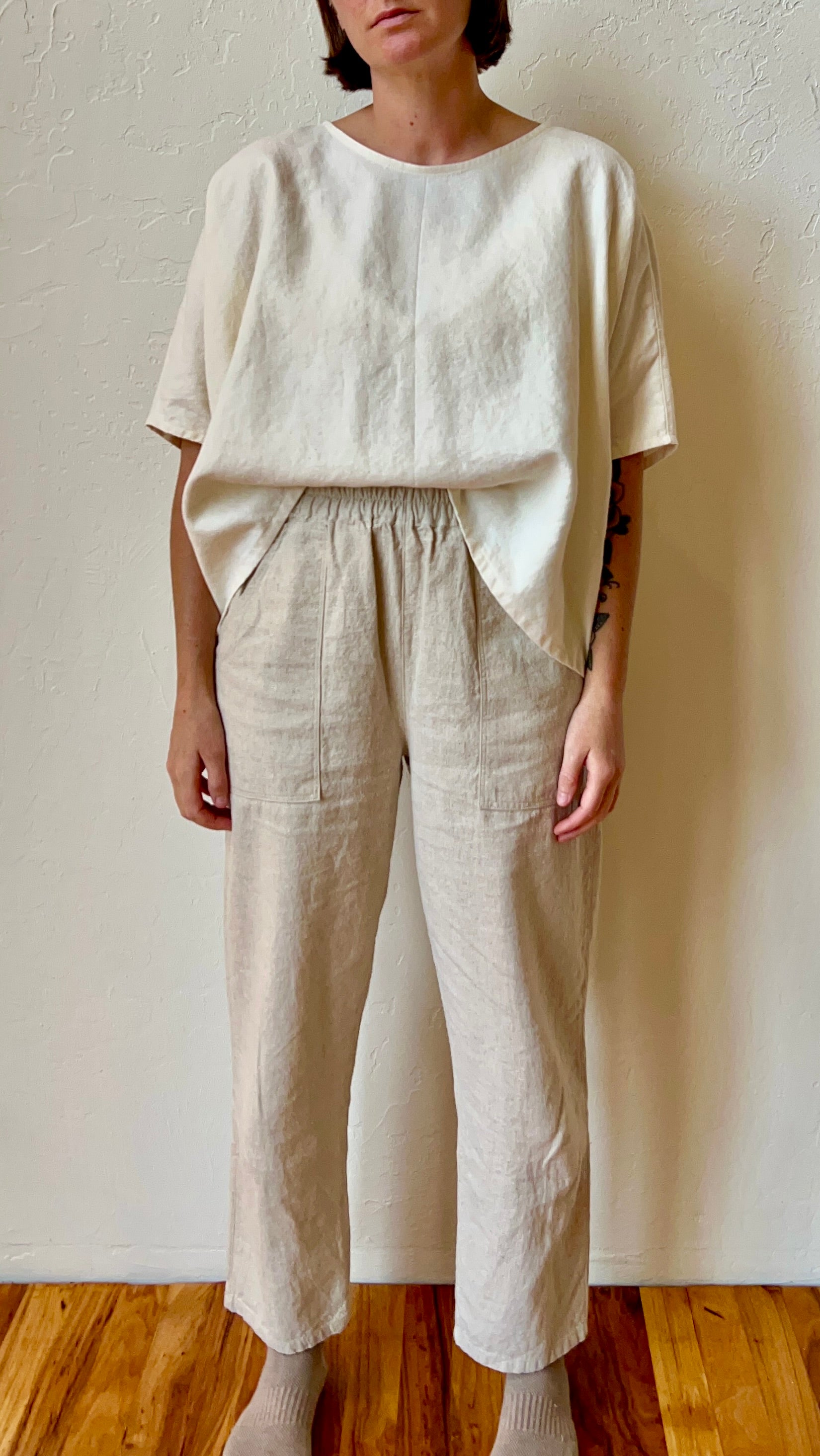 Person wearing a beige hemp outfit with a plain background