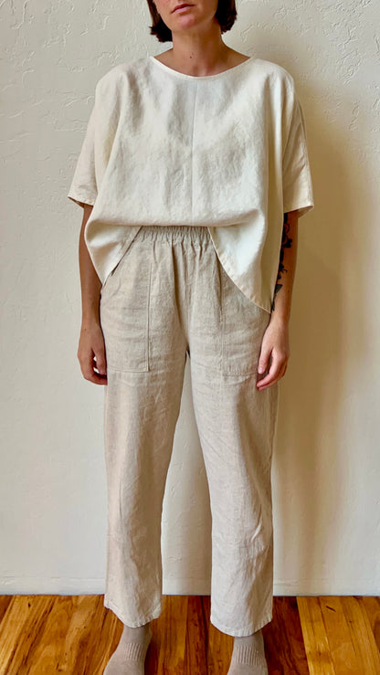 Person wearing a beige hemp outfit with a plain background