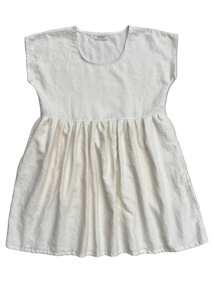 White hemp dress with gathered waist on a white background