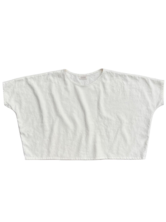 White crop top on a gray background