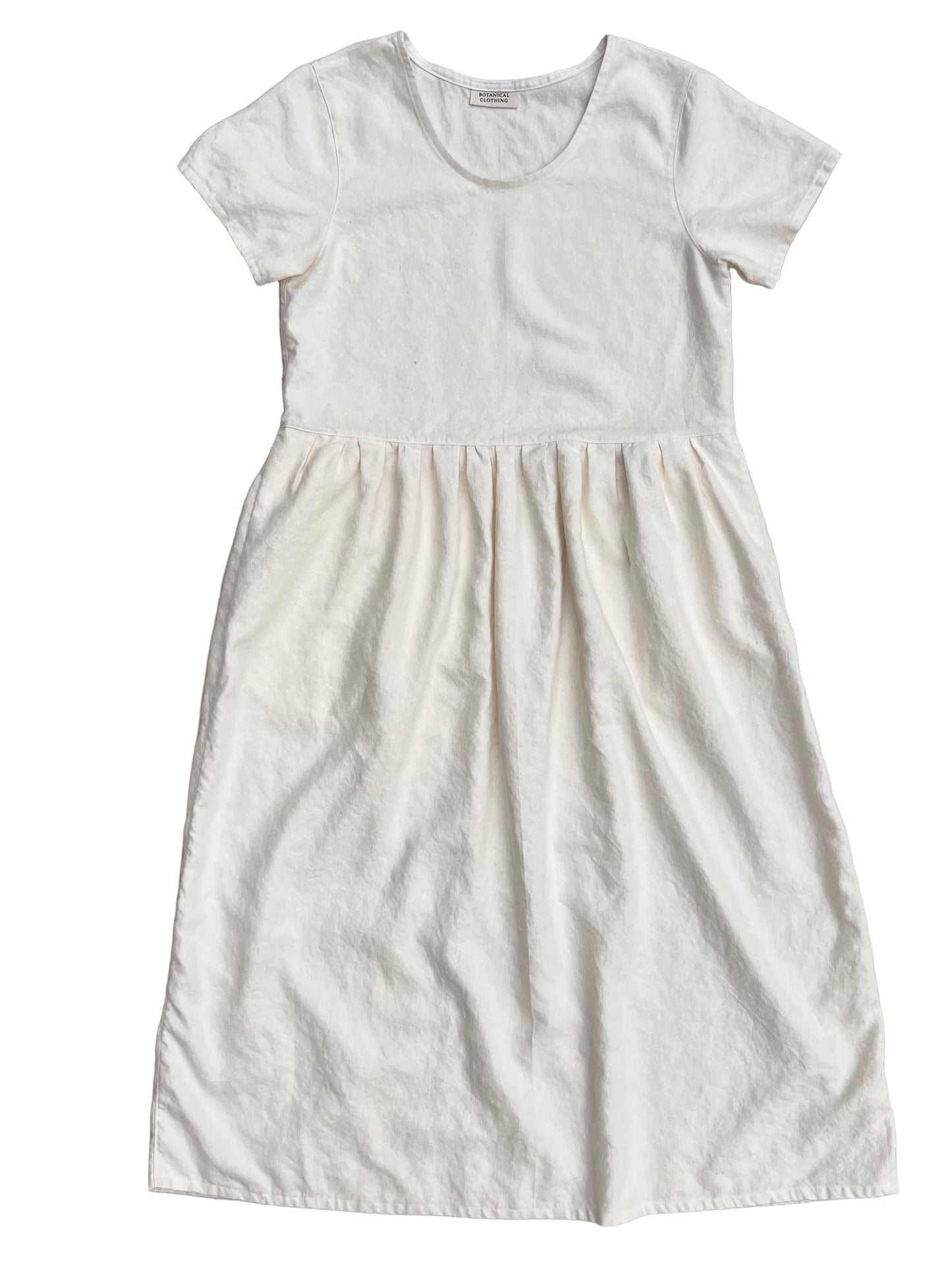 Long white organic hemp dress with pockets on a gray background