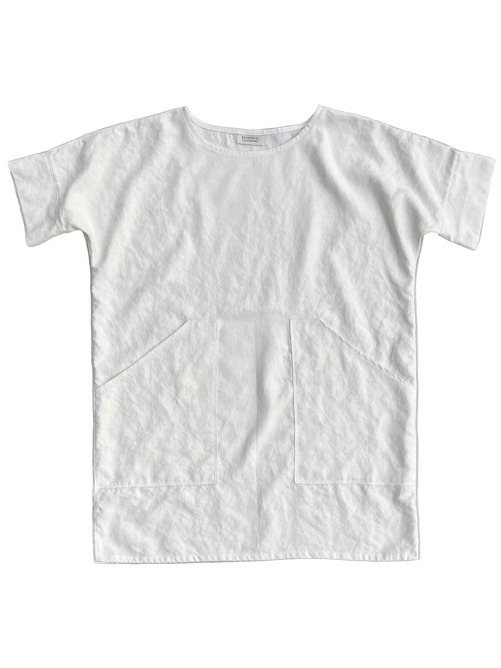 White hemp tunic with pockets on a light gray background