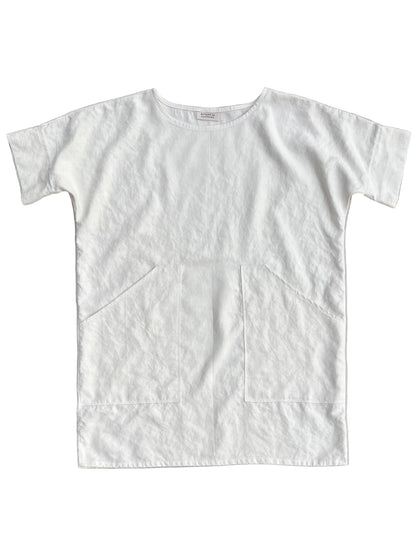 White hemp tunic with pockets on a light gray background