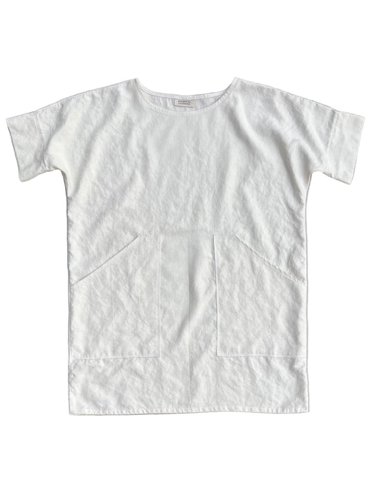 White hemp tunic with pockets on a light gray background