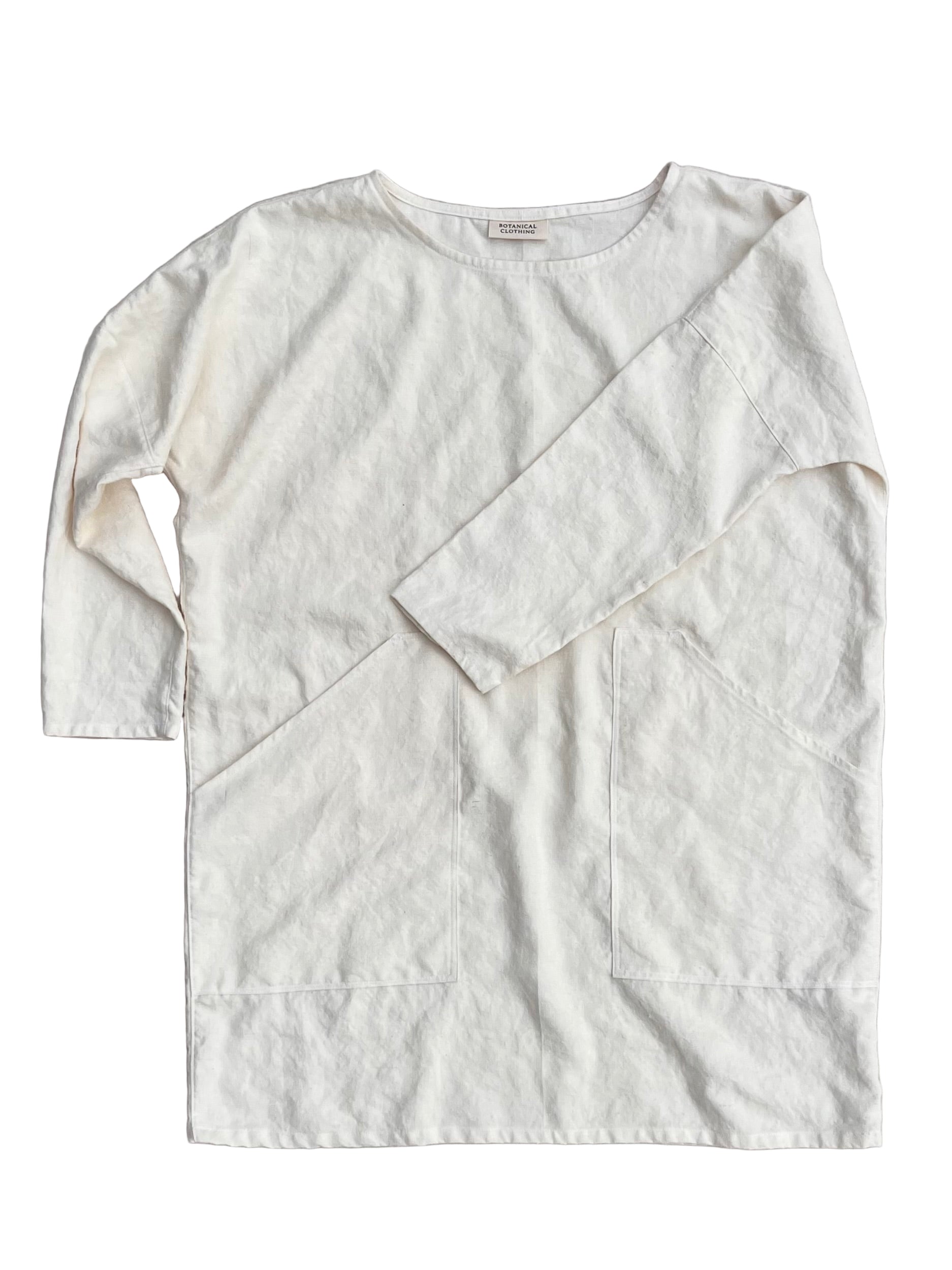 white hemp tunic with long sleeves and pockets on a white background