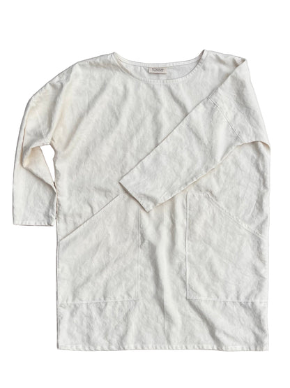 white hemp tunic with long sleeves and pockets on a white background